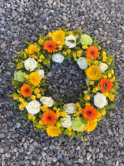 bright flowers funeral wreath made by florist from Croydon, UK