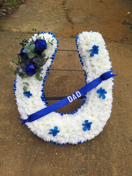 2D Horseshoe tribute with metal stand. Colours of ribbon and sprays can be changed By Croydon Blooms florist