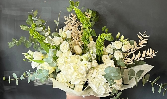 Stunning luxury all white bouquet made of hydrangeas and roses and dry elements made by florist in Croydon, Surrey, UK