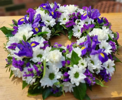 white and purple funeral wreath
