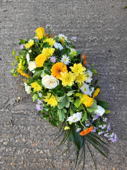 Compact look teardrop to include white roses, daisies, chrysanthemums, yellow daisies, roses and lilac fillers by Croydon Blooms florist