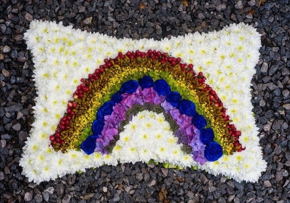 funeral rainbow on based pillow by Croydon Blooms Florist