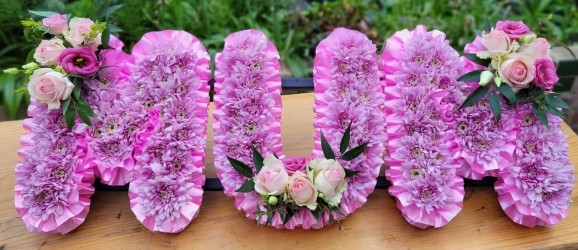 pink based funeral letters made by florist in Croydon