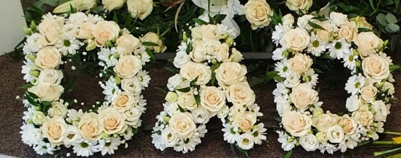 mixed cream roses and white daisies funeral letters with a greenery and gypsophilium by florist in Croydon