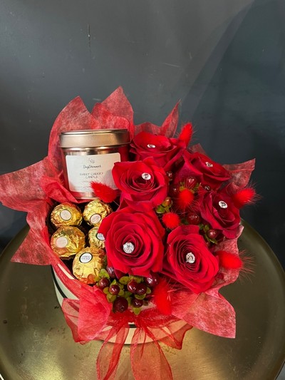 Amazing gift hat box with red roses, our daydreamer candle and Ferrero Rocher, made by florist in Croydon 