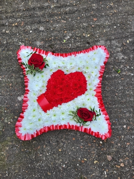 sprayed object on funeral cushion. By Croydon Blooms Florist