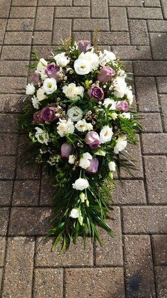 Stunning soft looking teardrop to include mixed white flowers, wax and lilac roses. By Croydon Blooms