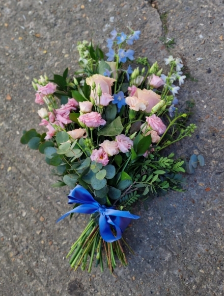 Lovely light blue & soft pinks sheaf to include Delphiniums and Roses by florist from Croydon