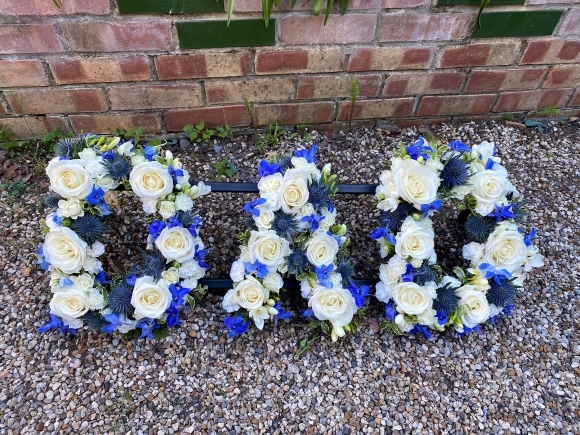 Mix of white roses, yellow spray roses, delphiniums and white fillers. by Croydon Blooms Funeral Florist Croydon