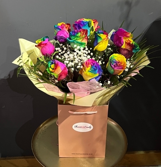 Stunning large heads of rainbow Roses bouquet dressed with some fillers and foliages. Made by florist in Croydon