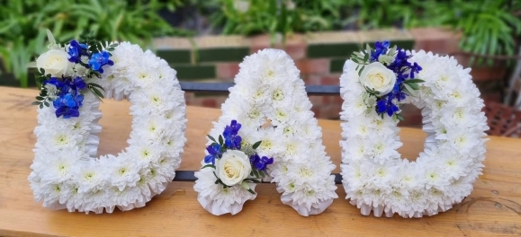 Chrysanthemum based DAD letters with white ribbon.