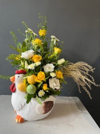Fresh flowers arrangement in a ceramic chicken pot decorated with nest with eggs.  A gift to put a smile on someone's face this Easter. By florist in Croydon 