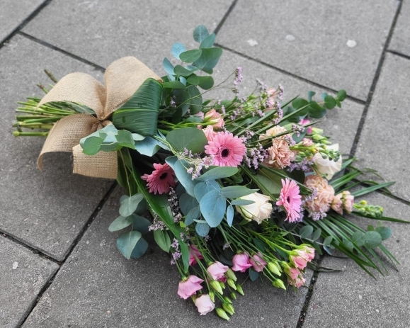 Florist Choice mixed flowers funeral sheaf tied with hessian ribbon. by Croydon Blooms