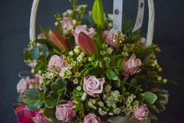 lovely arrangement of pink lilies and lilac roses in large 30cm white basket with exquisite Belgian Chocolates Box