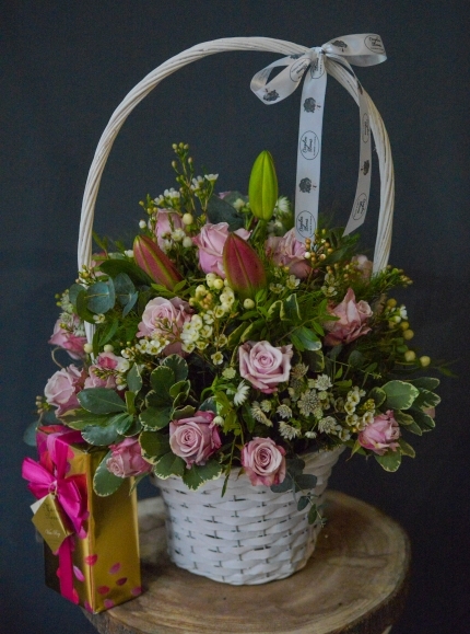 lovely arrangement of pink lilies and lilac roses in large 30cm white basket with exquisite Belgian Chocolates Box