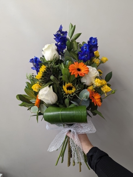 Mixed flowers funeral sheaf made by florist in Croydon, Surrey, UK