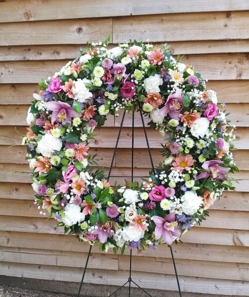 Stunning multicoloured funeral wreath to include cymbidium orchids.  easel included By funeral florist from Croydon 
