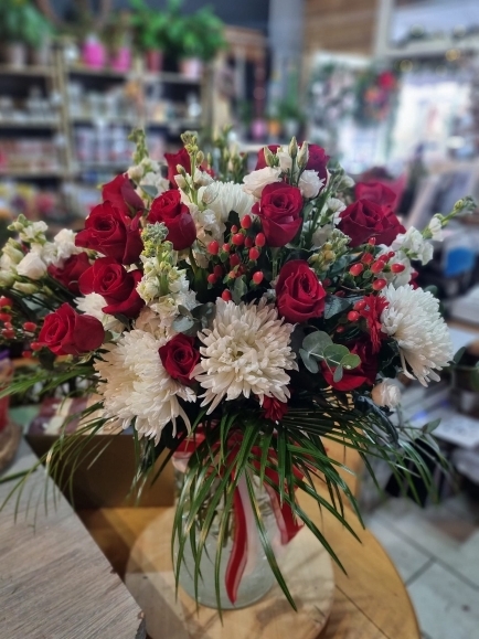 Big luxury flowers vase to include red roses, berries, white blooms, lisianthis, stock.