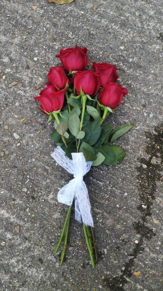 Simple Roses funeral sheaf tied with a bow made by florist in Croydon, Surrey, UK