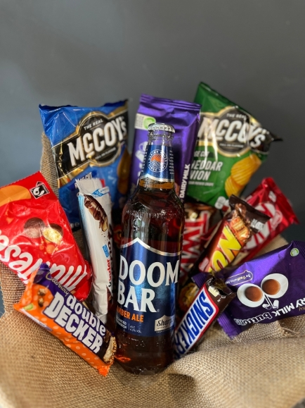 Mix of snacks with craft beer presented in a bouquet, gift wrapped.  bouquet to include:  craft beer, cadbury chocolate bar, kit kat bar, twix bar, snickers bar, random 2 packs of Crisps McCoys, maltesers, lion bar, Kinder Bueno bar, button Cadbury pack, double decker bar. Made by florist in Croydon, Surrey, UK for same day delivery in CR0 CRO CR2 CR3 CR4 CR5 CR6 CR7 CR8 SE25 BR4 BR3 BR2