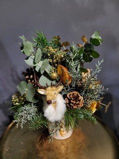 Elegant arrangement with Christmas foliages and winter decorations to include stag head. All nicely presented in ceramic stag pot for lovely display. Arrangement is approximately 50cm tall. Made by local florist in Croydon CR0 CRO in Surrey, Great Britain for guaranteed Christmas delivery 