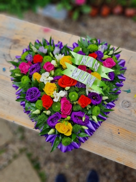 Funeral solid, full heart tribute made of deep purples, green, deep pink colours made by local independent florist in Croydon for free funeral service delivery in Croydon, East Croydon, West Croydon, South Croydon, Purley, Kenley, Coulsdon, West Wickham, Shirley, Addiscombe, Addington, New Addington, Gravel Hill, Selsdon, Hayes, Cony Hall, Becken, Elmers End, Bromley