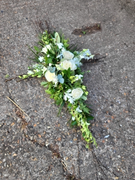 Woodland cross build on willow with Singapore orchid and roses by  Croydon Blooms florist 